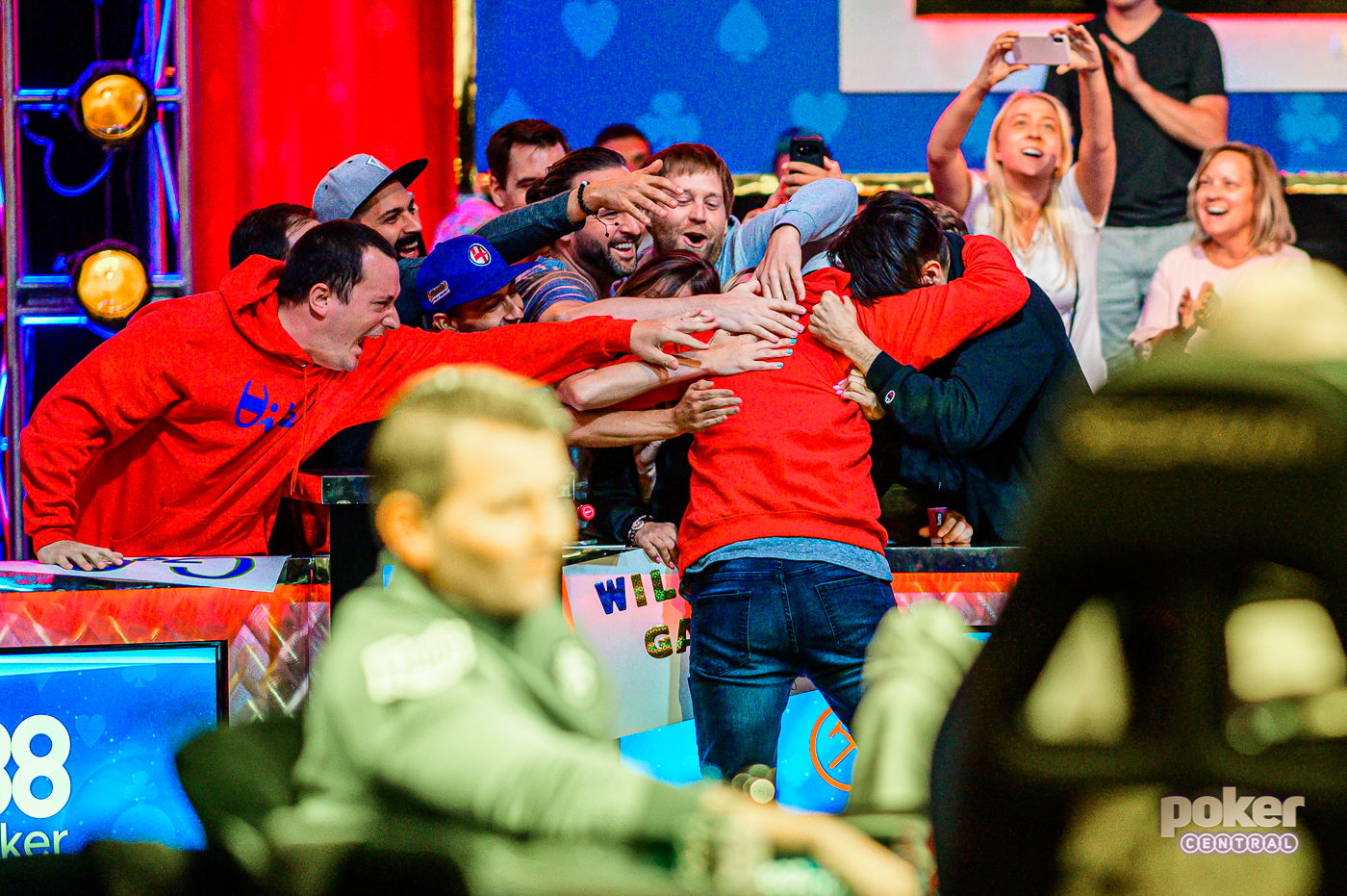 Garry Gates jumps into the arms of his friends and girlfriend celebrating after a big pot.