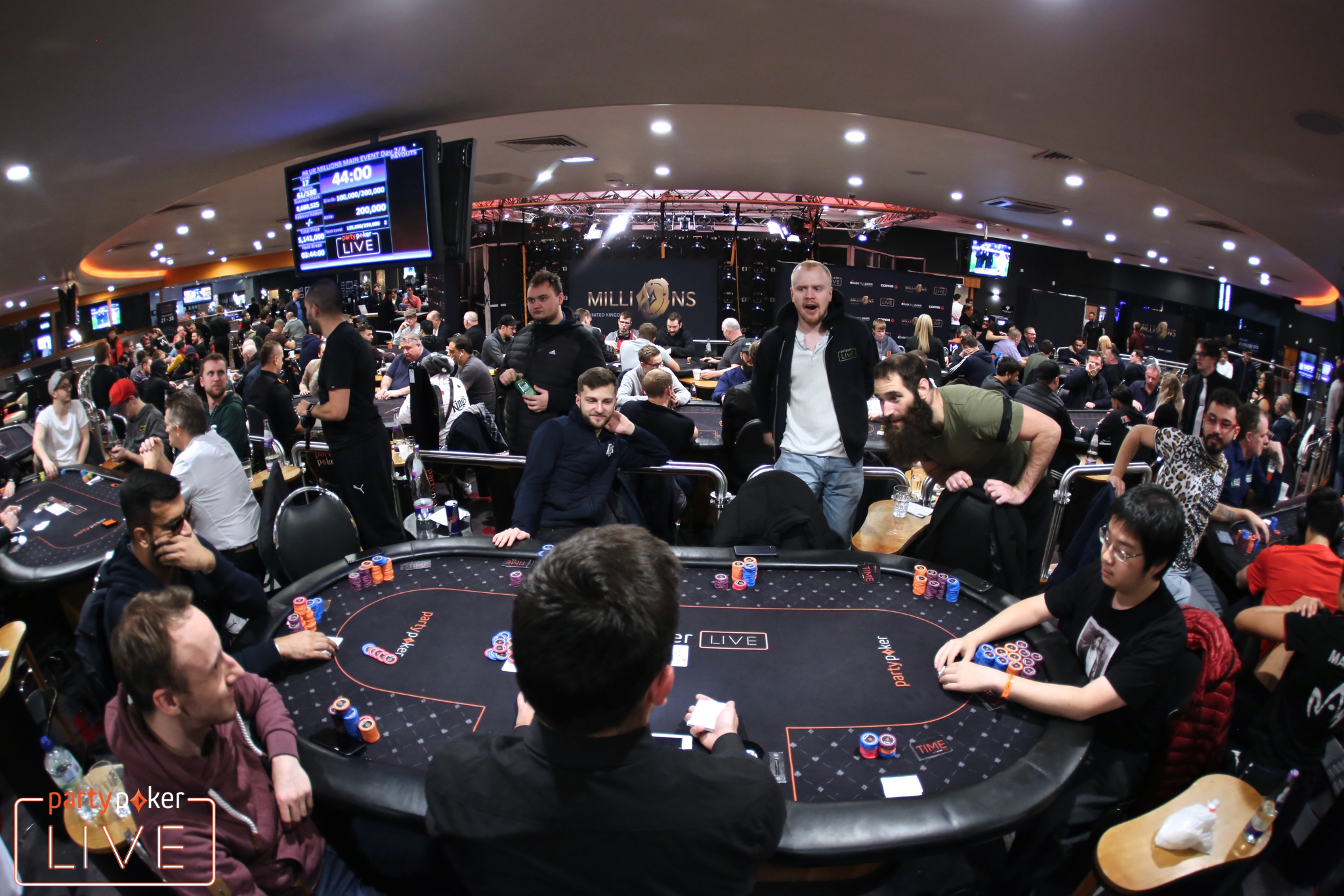 Kuljinder Sidhu (left, seat 2) bubbles the partypoker MILLIONS UK Main Event in a hand against Peter Chien (right, seat 7) (photo: Mickey May/partypoker)